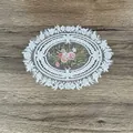 Detailed view of an oval embroidered lace placemat featuring a pink rose floral design - A Flower Heart Style / 17*22CM White