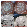 Detailed view of various sizes and patterns of European vintage lace tablecloths. - 130cm Round / Camel