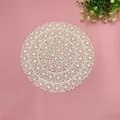 Detailed close-up view of a cream round lace doily with delicate floral woven patterns. - Clover Glossy Cream