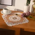 Detail of a vintage square lace doily with elegant floral embroidery on a wooden table. - 30CM Square / Camel