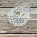 Elegant white floral lace doily table mat on a wooden surface with lifestyle props - Round Flower Style / White