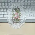 Close-up of oval white lace placemat with elegant pink rose embroidery. - 1A Oval Style / 12*16CM White