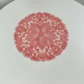 Detail of pink embroidered lace placemat with hollow floral design for table decor - 27x27cm / Watermelon red