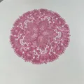 Detailed view of a round pink embroidered lace placemat with delicate floral patterns - 27x27cm / Rouge Red
