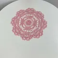 Detailed macro shot of pink embroidered floral lace coaster with scalloped edges - 28cm Round / Pink