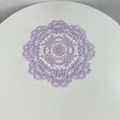 Close-up of a circular purple lace placemat featuring intricate floral embroidery - 28cm Round / Light Purple