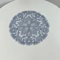 Detailed view of a blue embroidered lace placemat with intricate hollow patterns - 27x27cm / Light Gray
