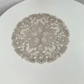 Detailed view of intricate floral lace embroidery on circular beige doily - 27x27cm / Grey Camel