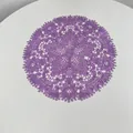 Close-up of purple embroidered lace placemat with intricate floral hollow design - 27x27cm / Purple