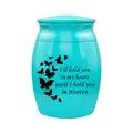Close-up detail of a turquoise memorial urn featuring butterfly patterns and quote - Blue (Butterfly Quotes)