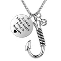 Detailed view of stainless steel fish hook cremation urn necklace with memorial tag - A Piece Of My Heart Lives In Heaven Style (No. 2) / Silver