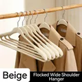 Beige flocked wide-shoulder clothes hanger with non-slip velvet finish for garments. - Flocking Style / 1 Piece / Off White