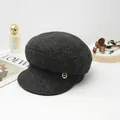 Detailed view of dark grey wool newsboy cap featuring a vintage gold side button accent - Dark Heather Gray