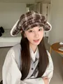 Detailed view of a sweet plaid octagonal hat with plush rabbit ears worn by a model - Coffee