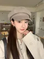 Close-up of a stylish retro beige newsboy hat worn by an Asian model in a cozy cafe setting - Mocha