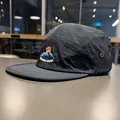 Detail view of the mountain embroidery on a black quick-dry flat brim camper hat - Classic Black