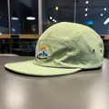 Close-up detail of sage green quick-dry five-panel cap with mountain embroidery - Light Pea Green