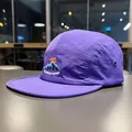 Close-up detail of a purple quick-dry five-panel camp hat featuring mountain embroidery - Taro Purple