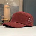 Close-up side view of a burgundy cotton military cadet cap with six silver metal eyelets - Burgundy