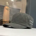 Detailed side view of a charcoal cotton flat top military cap with metal eyelets. - Gray