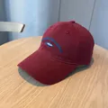 Vintage washed burgundy baseball cap featuring a unique blue fish embroidery design - Red