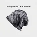 Detail view of the vintage leopard print texture on a lightweight slouchy beanie. - Gray