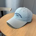 Classic washed light blue baseball cap featuring unique small fish embroidery and text detail - Sky Blue