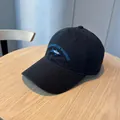 Classic black washed cotton baseball cap with blue fish and text embroidery detail - Black