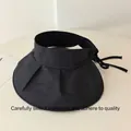 Macro view of black wide-brim sun visor hat with foldable pleated design - Black