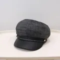 Close-up of a grey wool and black leather newsboy cap for women in winter. - Black and Gray Mixed