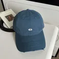 Distressed slate blue baseball cap with oval metal logo and wide sunshade brim - Green Gray