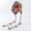 Detailed view of handmade crochet boho beanie with colorful flowers and long tassels - Caramel color