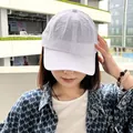 Detail view of a white quick-dry baseball cap on a model for outdoor sports and sun protection - White