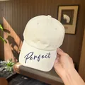 Close-up of the 'Perfect' cursive embroidery on a stylish beige baseball cap. - Regular (55-59cm) / Beige