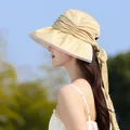 Side profile view of elegant pleated sun hat with mesh trim and large decorative bow - Yellow