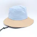Detailed view of two-tone sun protection bucket hat in blue and beige nylon fabric - Khaki