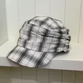 Detailed view of a retro British style plaid newsboy cap with unique pleated fabric design - White Plaid