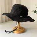 Breathable black outdoor bucket hat with wide sunshade brim and adjustable chin strap - Black