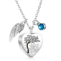 Primer plano de un colgante de cremación en forma de corazón con grabado de árbol y piedra - Corazón con Alas y Colgante de Piedra de Nacimiento / Azul cielo