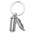Macro detail of stainless steel cylinder pet urn keychain with vintage feather charm - Leaf Keyring Style / 11x28mm / Silver