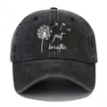 Detail showing a vintage washed denim baseball cap with dandelion print and 'just breathe' text - Adjustable / Black