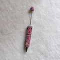 Close-up detail of handmade pink rhinestone beadable pen decorated with colorful gems - Pink with AB Rhinestones