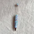 Detail of a decorative beadable pen with blue butterflies and pearls on plush fabric - Blue Purple Gradient Butterfly Style (蝴蝶圆珠笔)