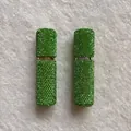 Close-up of two green rhinestone-encrusted 10ml portable perfume spray bottles - Green