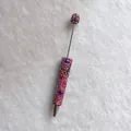 Close-up of handmade colorful rhinestone pen with sparkling crystals on white background - Red with AB Rhinestones