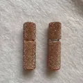 Detail view of two 10ml refillable perfume atomizers covered in champagne rhinestones - Champagne
