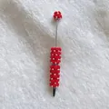 Handmade decorative beaded ballpoint pen with red fuzzy hearts and white pearl accents. - Red