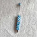 Detailed view of a beaded ballpoint pen decorated with blue butterflies and pearls - Solid Blue Butterfly Style (蝴蝶圆珠笔)