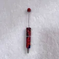 Handmade ballpoint pen with red and blue rhinestones and sleek metal rod design - Red