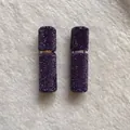 Close-up of portable 10ml perfume atomizers fully embellished with purple crystals - Deep purple